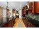 Well-equipped kitchen with stainless steel appliances, dark wood cabinetry, and a large island at 5305 Sagecrest Dr, Lithia, FL 33547