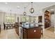 Open kitchen with large island, seating, stainless dishwasher, and adjoining dining and living areas at 5305 Sagecrest Dr, Lithia, FL 33547