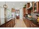 Well-equipped kitchen features dark wood cabinets, a large island, modern appliances and stylish countertops at 5305 Sagecrest Dr, Lithia, FL 33547