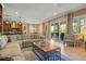 Bright living room featuring a comfortable sofa, stylish decor, and sliding glass doors to the patio at 5305 Sagecrest Dr, Lithia, FL 33547