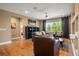 Spacious living room with hardwood floors, a large window, and comfortable leather seating at 5305 Sagecrest Dr, Lithia, FL 33547