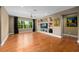 Bright and spacious living room showcasing hardwood floors and natural light with a built-in media center at 5305 Sagecrest Dr, Lithia, FL 33547