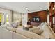 Comfortable living room with lots of natural light, wood accent wall, and open floor plan at 5305 Sagecrest Dr, Lithia, FL 33547