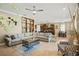 Open-concept living room with large sectional sofa, modern decor, and view to dining area and kitchen at 5305 Sagecrest Dr, Lithia, FL 33547