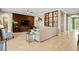 Open-concept living room with modern furnishings, a unique wood-paneled wall, and built-in shelving at 5305 Sagecrest Dr, Lithia, FL 33547