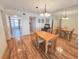 Cozy dining area with wood floors and a charming chandelier for Gathering gatherings at 6020 Shore S Blvd # 1009, Gulfport, FL 33707