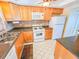 Efficient kitchen featuring wood cabinets, modern appliances, and neutral countertops at 6020 Shore S Blvd # 1009, Gulfport, FL 33707