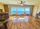 Bright living room showcasing the water view and gleaming wood floors at 6020 Shore S Blvd # 1009, Gulfport, FL 33707