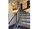 Grand staircase with iron railing, carpeted steps, and decorative chandelier, offering a unique design at 604 Druid Hills Rd, Temple Terrace, FL 33617