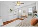 Bedroom featuring wood floors, a cozy daybed, desk, and natural light at 7014 Grevilla S Ave, South Pasadena, FL 33707