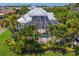 Aerial view of estate showcasing the pool, covered patio, landscaping, and lush greenery surrounding the property at 708 Islebay Dr, Apollo Beach, FL 33572