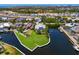Waterfront home with a lush lawn, boat dock, and stunning views of the surrounding community and waterways at 708 Islebay Dr, Apollo Beach, FL 33572