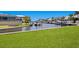 A lush green lawn leads to a canal offering access to waterfront living and boating at 708 Islebay Dr, Apollo Beach, FL 33572