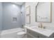 Bathroom featuring a modern vanity, marble countertops, and stylish fixtures with tub-shower combo at 708 Islebay Dr, Apollo Beach, FL 33572