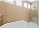 Close up view of a freestanding tub and walk-in shower with sleek fixtures in the bathroom at 708 Islebay Dr, Apollo Beach, FL 33572