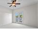 Bedroom showcasing french doors, a ceiling fan, and carpeted floors with a view of the outdoor scenery at 708 Islebay Dr, Apollo Beach, FL 33572