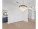 Bright room with hardwood floors and a tiered chandelier at 708 Islebay Dr, Apollo Beach, FL 33572