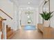 Bright foyer featuring hardwood floors, a modern light fixture, and a view of the front door at 708 Islebay Dr, Apollo Beach, FL 33572