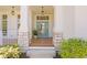 Charming front porch with stone accents, a wooden deck, and a stylish blue front door at 708 Islebay Dr, Apollo Beach, FL 33572
