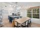 A contemporary open floor plan featuring kitchen with island, and adjacent dining area at 708 Islebay Dr, Apollo Beach, FL 33572