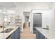 Bright kitchen with island that leads to a living space and stainless steel appliances at 708 Islebay Dr, Apollo Beach, FL 33572