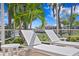 Beautiful patio with lawn chairs perfect for relaxing on a sunny day with mature landscaping and water view at 708 Islebay Dr, Apollo Beach, FL 33572
