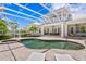 A covered pool and patio create the perfect backyard space with a spa, multiple sitting areas, and lush landscaping at 708 Islebay Dr, Apollo Beach, FL 33572