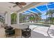 Outdoor pool area complete with a screened enclosure, dining table, chairs, and beautiful waterfront views at 708 Islebay Dr, Apollo Beach, FL 33572