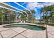 Inviting screened-in pool area with a spa, tiled patio, and comfortable lounge chairs for relaxation at 708 Islebay Dr, Apollo Beach, FL 33572