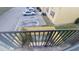 Balcony area with a yellow picket fence and view of the parking lot and side of the building at 7502 Bolanos Ct, Tampa, FL 33615