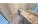 Clean bathroom features a vanity with drawers, a marble countertop, and tiled floors at 7502 Bolanos Ct, Tampa, FL 33615