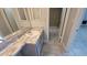 Bathroom features a tiled floor, vanity with marble countertop, and shower tub combination at 7502 Bolanos Ct, Tampa, FL 33615