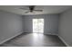 Bright bedroom featuring a ceiling fan and a sliding glass door leading to a balcony at 7502 Bolanos Ct, Tampa, FL 33615