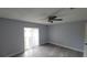 Spacious bedroom featuring a ceiling fan and a sliding glass door leading to a balcony at 7502 Bolanos Ct, Tampa, FL 33615