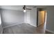 Spacious bedroom featuring modern gray vinyl flooring and a contemporary ceiling fan with light fixture at 7502 Bolanos Ct, Tampa, FL 33615