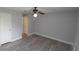 Bright bedroom featuring light gray vinyl flooring and a ceiling fan, freshly painted and move-in ready at 7502 Bolanos Ct, Tampa, FL 33615