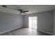 Neutral bedroom with a ceiling fan and sliding glass door, offering ample natural light at 7502 Bolanos Ct, Tampa, FL 33615
