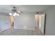 Light-filled bedroom with tile flooring, a ceiling fan and an ensuite bathroom at 7502 Bolanos Ct, Tampa, FL 33615