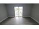 Neutral bedroom featuring light gray flooring, a sliding glass door and outside view at 7502 Bolanos Ct, Tampa, FL 33615