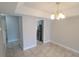 Neutral dining room showcasing the chandelier and the tile flooring that leads to the kitchen at 7502 Bolanos Ct, Tampa, FL 33615