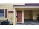 Close up of condo front door with unit numbers, mailbox, light fixture, and carport support beam at 7502 Bolanos Ct, Tampa, FL 33615