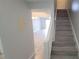 Inviting entryway with tile flooring, staircase, and view into the spacious living area at 7502 Bolanos Ct, Tampa, FL 33615