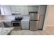 Kitchen featuring stainless steel appliances, ample counter space, and tile flooring at 7502 Bolanos Ct, Tampa, FL 33615