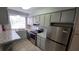 Kitchen featuring stainless steel appliances, sleek countertops, and double sink at 7502 Bolanos Ct, Tampa, FL 33615