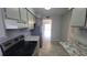 Well-lit kitchen featuring stainless steel appliances, stone countertops, and tile flooring at 7502 Bolanos Ct, Tampa, FL 33615