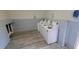 Community laundry room featuring several white top-loading washing machines, updated floors, and fresh paint at 7502 Bolanos Ct, Tampa, FL 33615