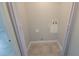 A compact laundry room with tiled floors and basic utility connections, space-efficient design at 7502 Bolanos Ct, Tampa, FL 33615