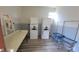 Community laundry room featuring stacked washer/dryer units, folding table, and utility cart at 7502 Bolanos Ct, Tampa, FL 33615