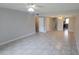 Open-concept living room showcasing tile flooring and access to other rooms at 7502 Bolanos Ct, Tampa, FL 33615