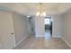 Spacious living room features tile flooring, modern lighting, and seamless transition to kitchen at 7502 Bolanos Ct, Tampa, FL 33615